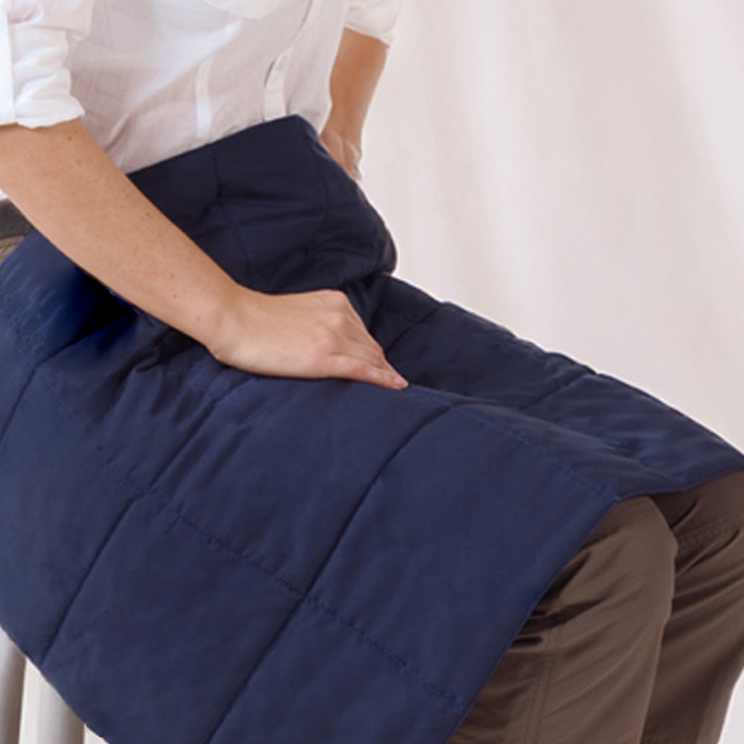 Repower-Cooling-Blanket-Ecooline-Repower-Cooling-Blanket-1500x1500px.jpg Repower Cooling Blanket for Heat Emergencies by E.COOLINE lying on a woman’s legs